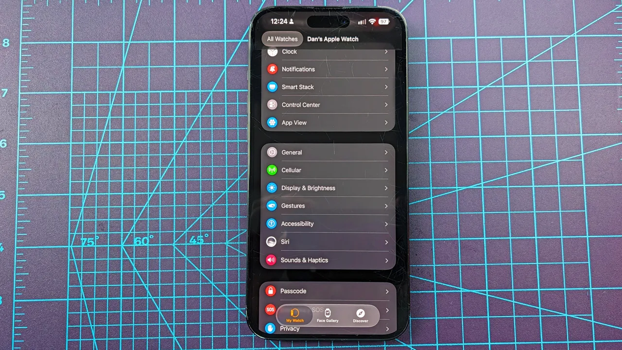 Close-up of an iPhone 16 Plus showing how to add the new step count widget to your Apple Watch's watch face