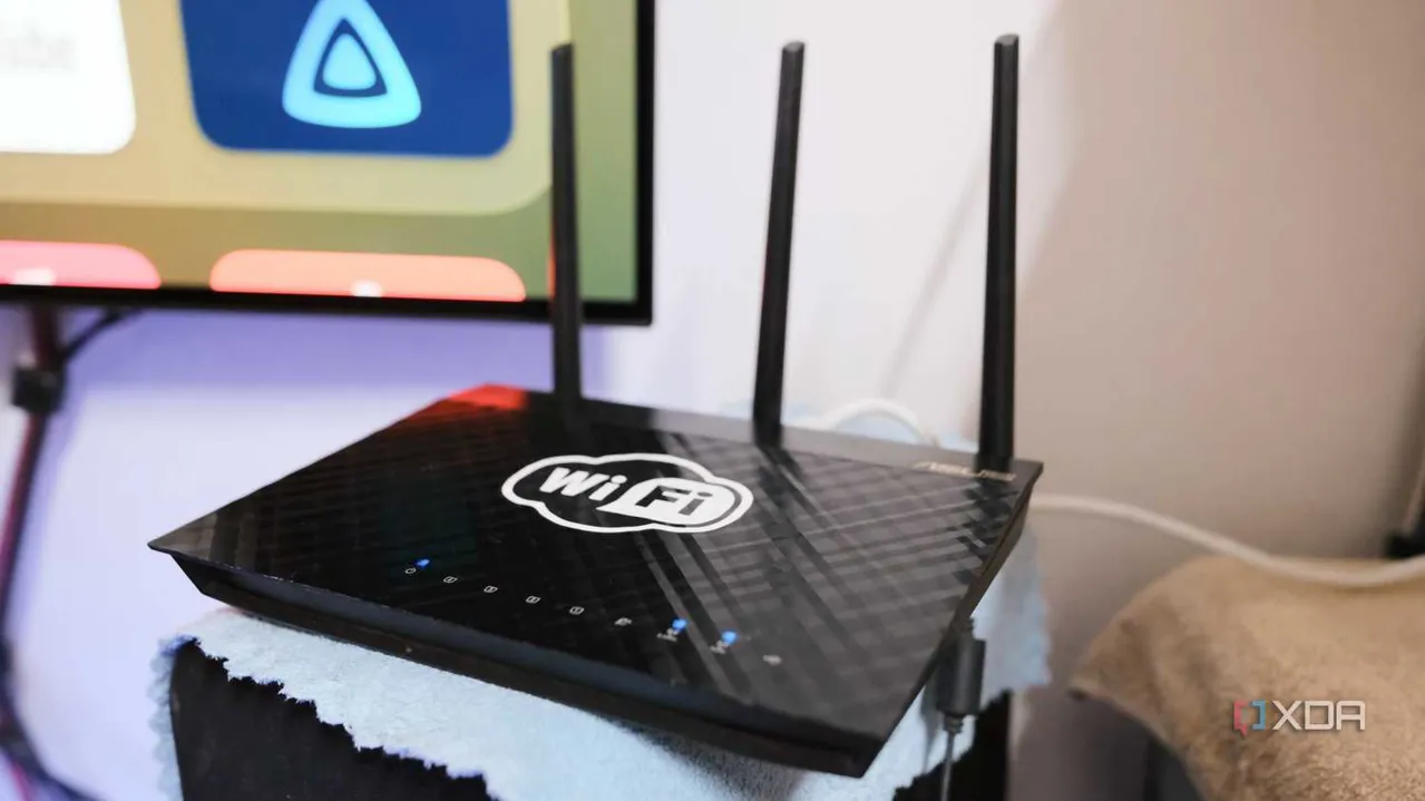 old router with antenna on top of PC