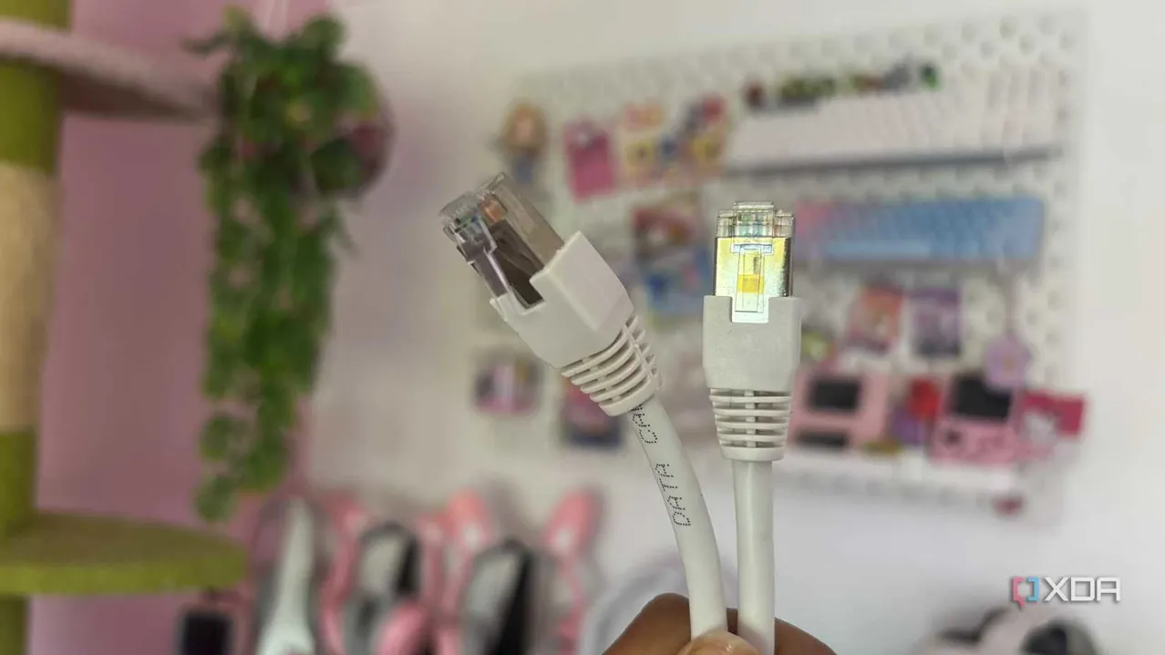 Teknoloji ürünlerinin bulunduğu rafta tutulan Ethernet kablosu