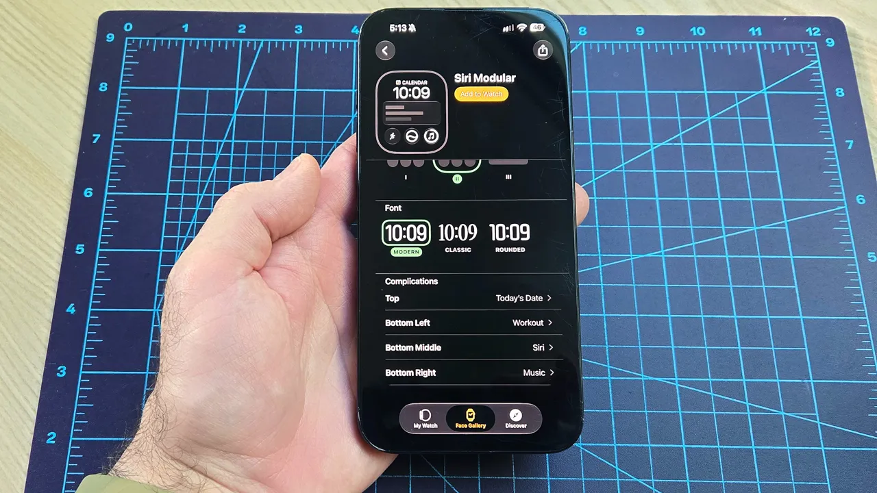 Close-up of an iPhone 16 Plus showing how to add the new step count widget to your Apple Watch's watch face